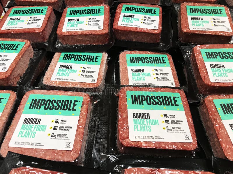 Impossible Foods brand plant-based Impossible Burgers available for vegan customers in the meat section of grocery store stock image