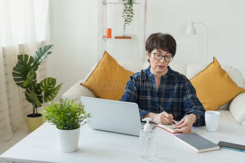 Imprenditrice o blogger che lavora sul computer portatile seduto a casa e che gestisce la propria attività attraverso l'ufficio do fotografia stock libera da diritti