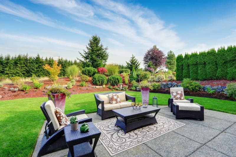 Impressive backyard landscape design with patio area