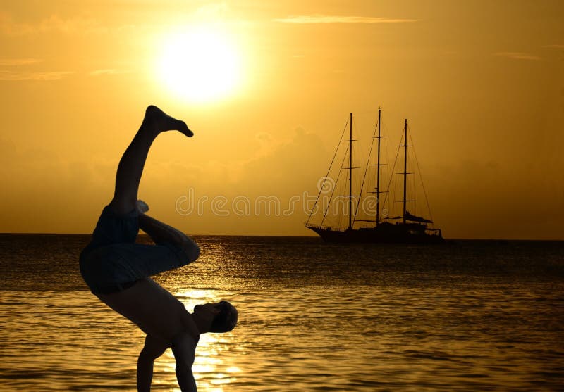 Joven atlético2 829 durante impresionante fuerza es un contra de hermoso Paraíso atardecer a barco de vela sobre el.