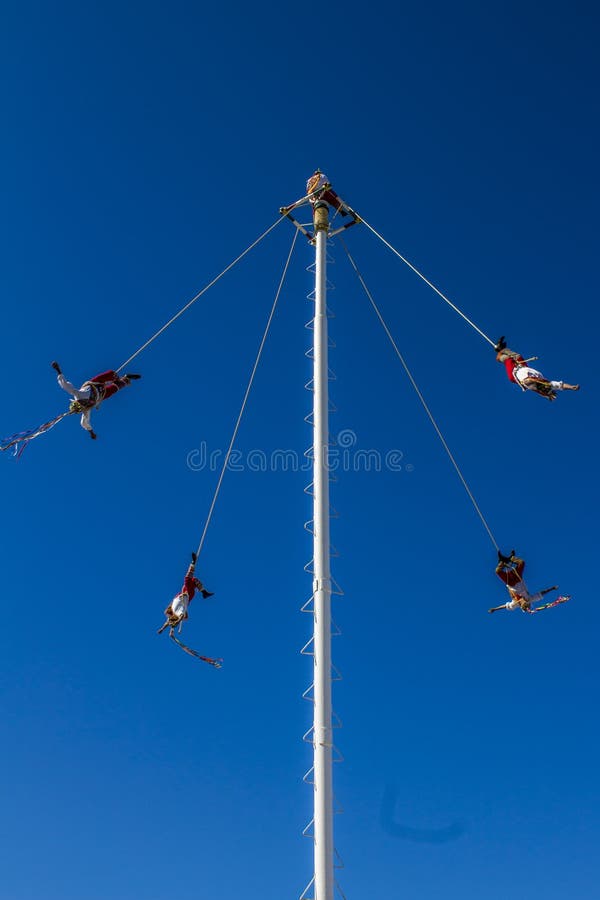 Impressive image of the Papantla flyers with a wonderful blue sky an ancient Mexican tradition mexican pre-columbian ariel dance in Puerto Vallarta Jalisco Mexico