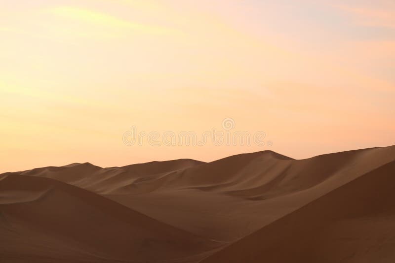 Impressive pastel color of sunset sky over the sand dune of Huacachina desert, Ica, Peru, South America