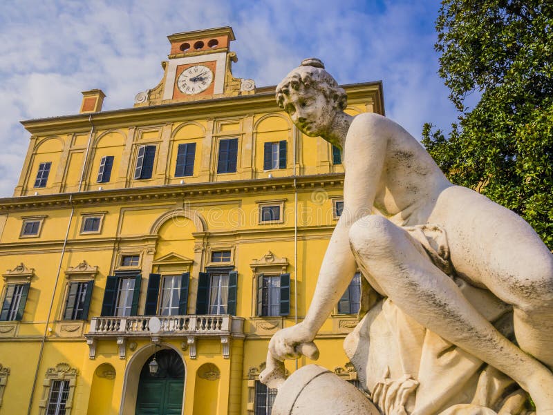 Ducal garden`s palace with close-up of marble statue, Parma, Italy