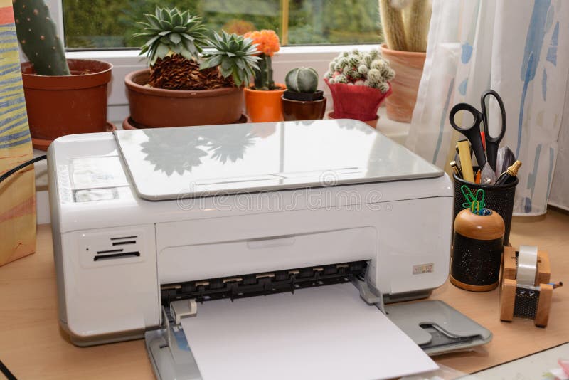 Inkjet printers and other accessories are at the desk in an office. Inkjet printers and other accessories are at the desk in an office