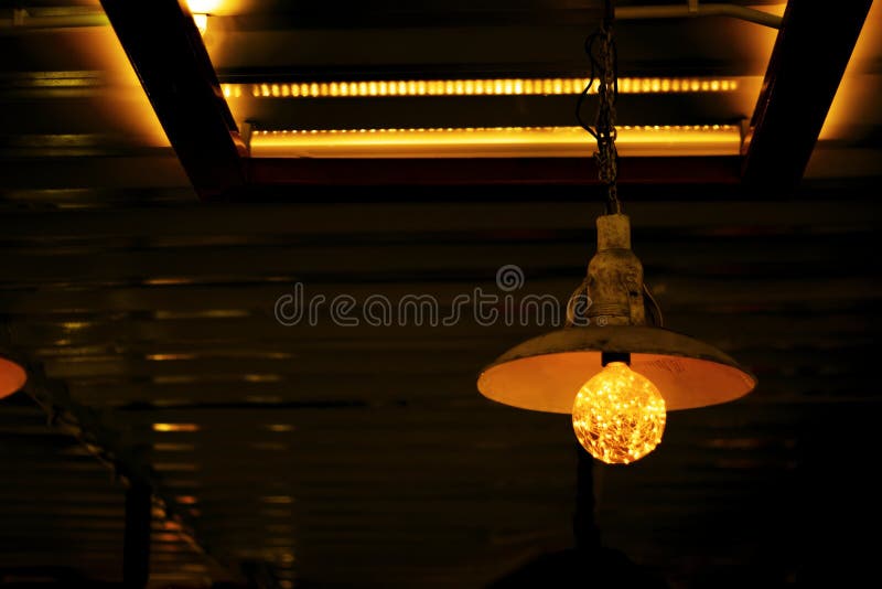 Incandescent Lamp Shining, Yellow Light of Lamp Hang on Ceiling Stock