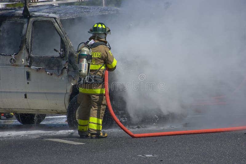 Fireman puts out car fire. Fireman puts out car fire