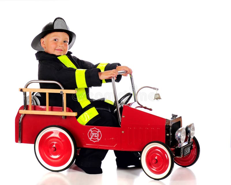An adorable preschool fireman dressed and ready for a fire in his truck. Isolated on white. An adorable preschool fireman dressed and ready for a fire in his truck. Isolated on white.