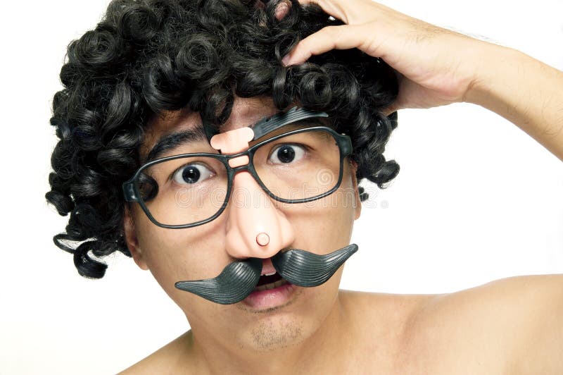 Portrait of a funny man with comedy eyeglasses looking confused over white background. Portrait of a funny man with comedy eyeglasses looking confused over white background.