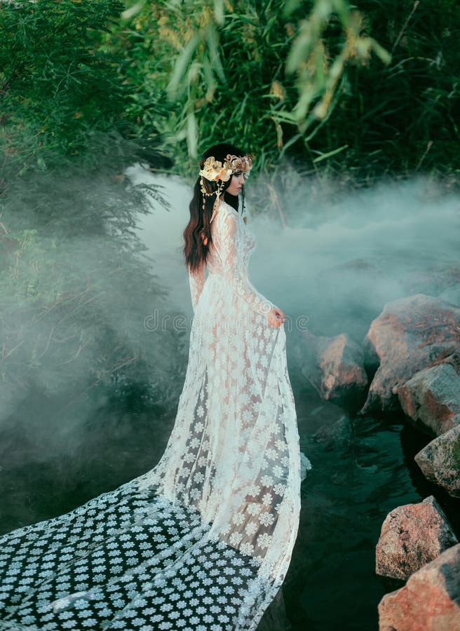 Incredible nymph, walks in the water in the middle of the river which was tightened by a thick, impenetrable fog. The mermaid has a white vintage, lacy dress. Feast of Ivan Kupala.