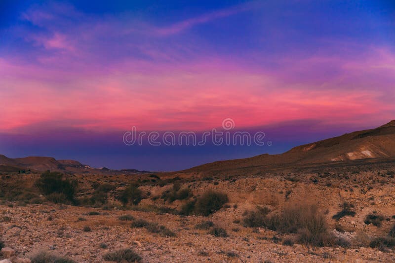 Incredible purple sunset in the Negev desert in Israel. Sunset with notes of pink, blue and dark blue.