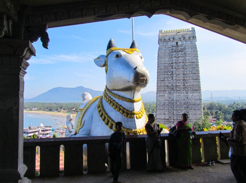 India, the state of Karnataka, the city of Murdeshwar. November 16, 2014. Statue of the sacred cow and Gopuram stock image India, the state of Karnataka, the city of Murdeshwar. November 16, 2014. Statue of the sacred cow and Gopuram stock image