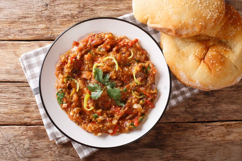 Indian Baingan Bharta eggplant, with tomatoes, garlic and spices close-up on a plate. horizontal top view