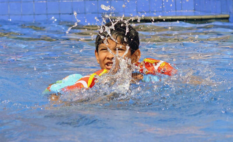 Asian Indian boy practicing Swimming in his summer camp royalty free stock photography Asian Indian boy practicing Swimming in his summer camp royalty free stock photography