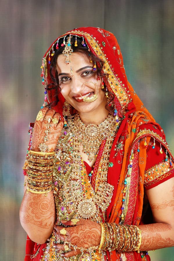 Indian bride in her wedding dress showing