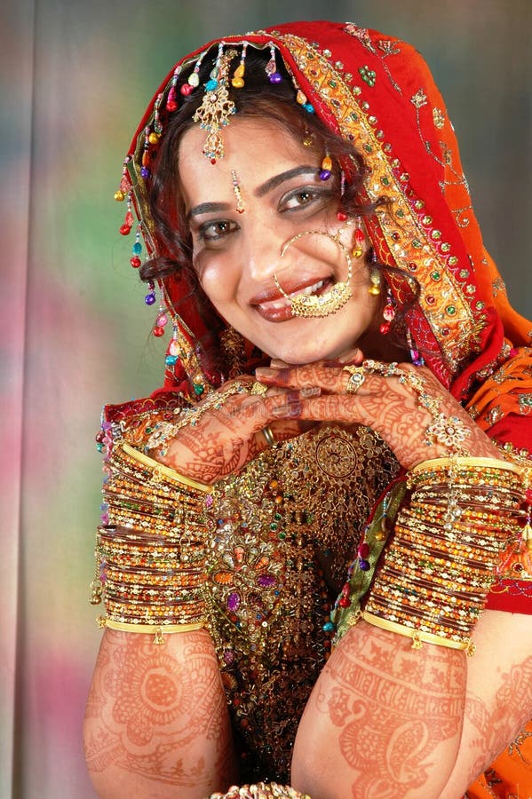 Indian bride in her wedding dress showing bangles