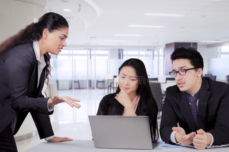 Indian business manager talking to her team in a meeting stock images Indian business manager talking to her team in a meeting stock images