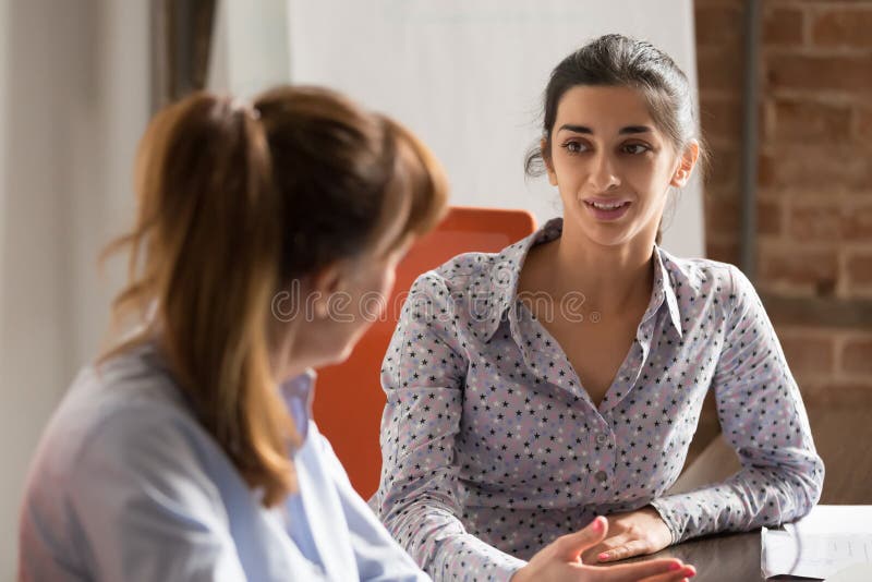 Indian businesswoman speaking consulting client at business office meeting stock photo Indian businesswoman speaking consulting client at business office meeting stock photo