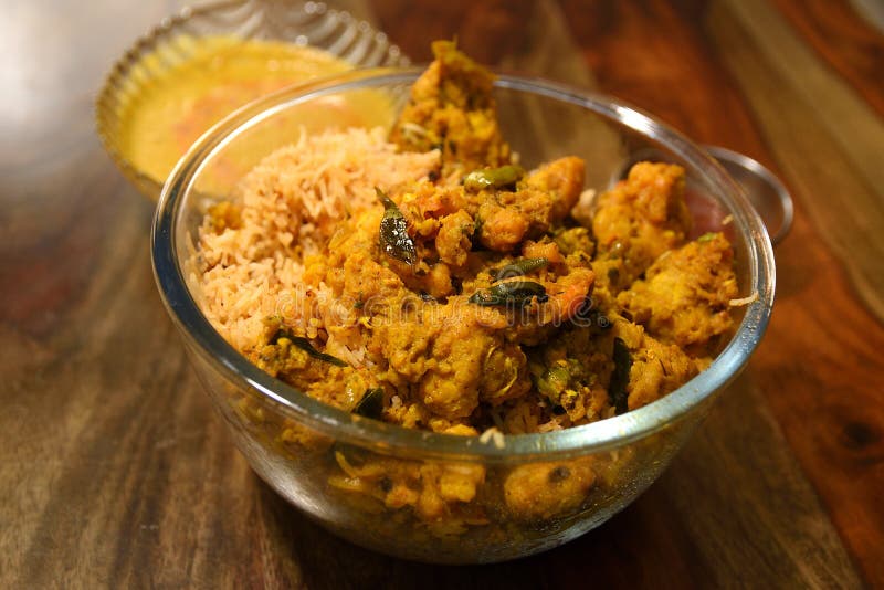 Indian Chicken Biryani served in a glass bowl with curry and sause over wooden background. Chicken dum biryani stock images, royalty-free photos and pictures