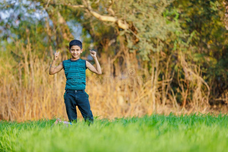 Indian child playing with kite at green field royalty free stock photo Indian child playing with kite at green field royalty free stock photo