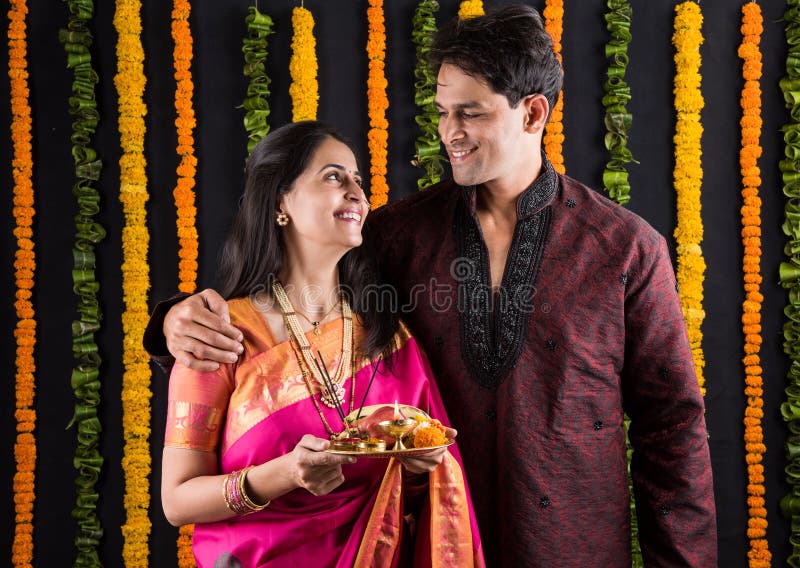Happy Diwali Day! Lovely Indian Couple In Love, Wear At Saree And Elegant  Suit, Posed On Restaurant And Hold Lantern Together. Stock Photo, Picture  and Royalty Free Image. Image 119276598.
