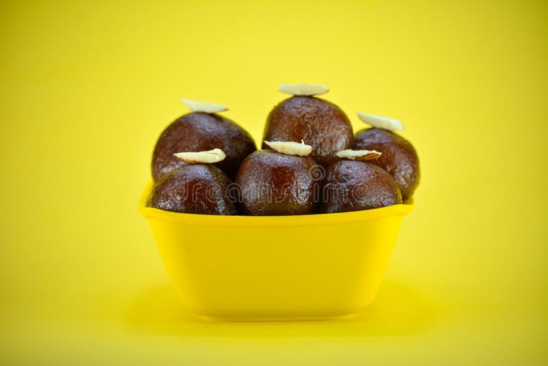 Indian Dessert Gulab Jamun Served In Yellow Bowl. Stock Photo Image