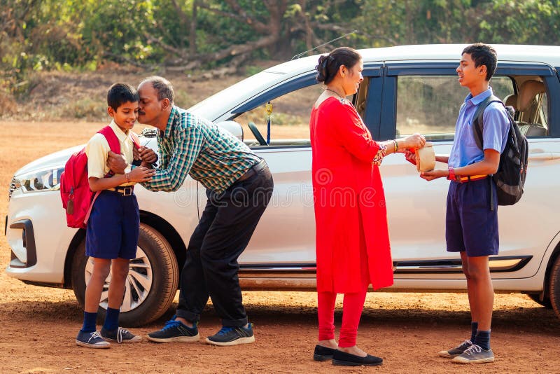 Indian family driving boys to school In front of house gates stock photography Indian family driving boys to school In front of house gates stock photography