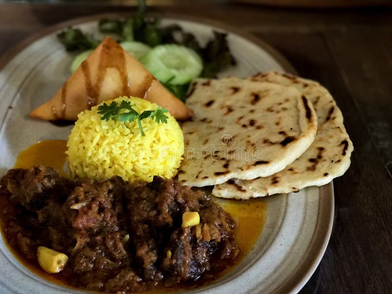 Indian Food or Indian Beef Curry serving in bowl with rice or roti,Dark and blurred background