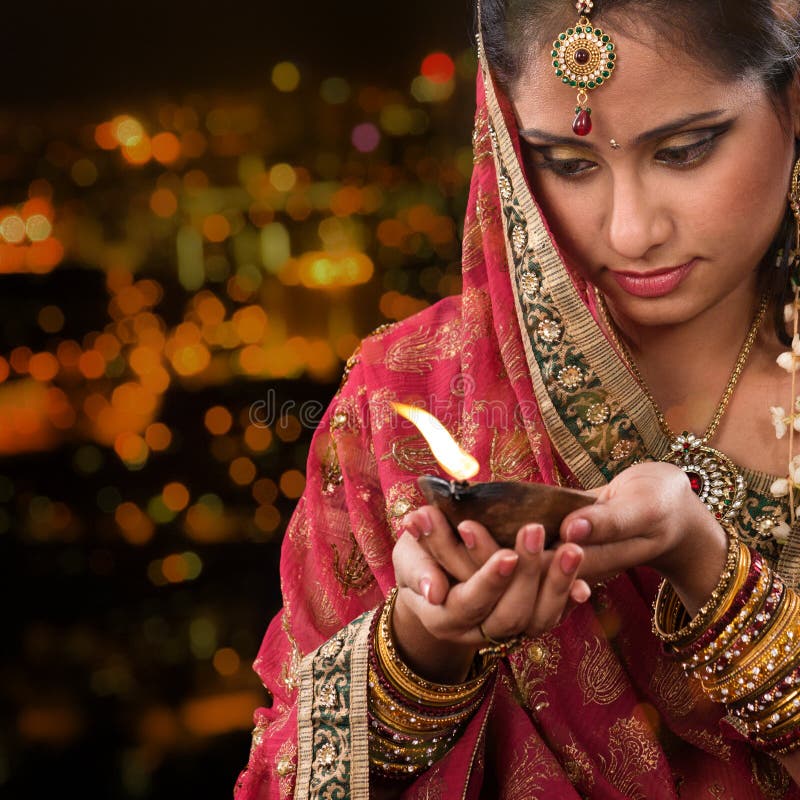 Indian girl hands holding diwali oil lamp