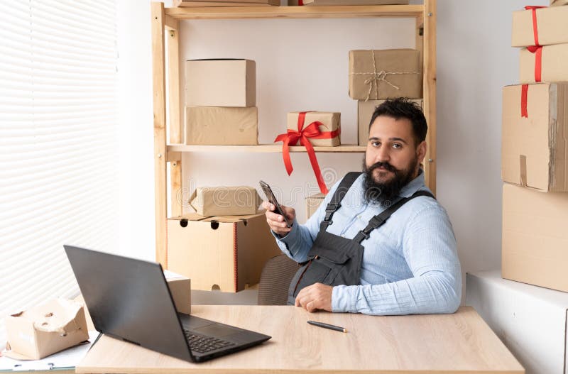 Indian Male Small Business Owner Using Mobile App on Smartphone