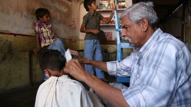 Indian Man Cutting Boy S Hair At A Salon In Jodhpur. Stock ...