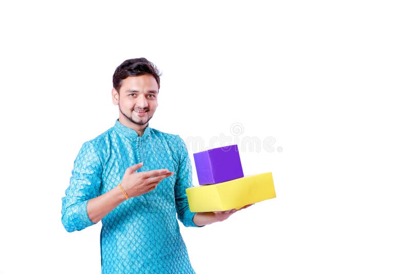 Indian man in ethnic wear and Holding gift box in hand , isolated over white background
