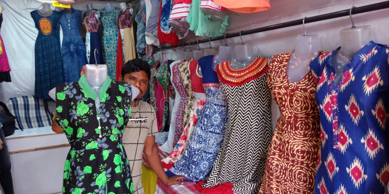 Indian Man Presenting Frock Design at Local Garments Shop in India