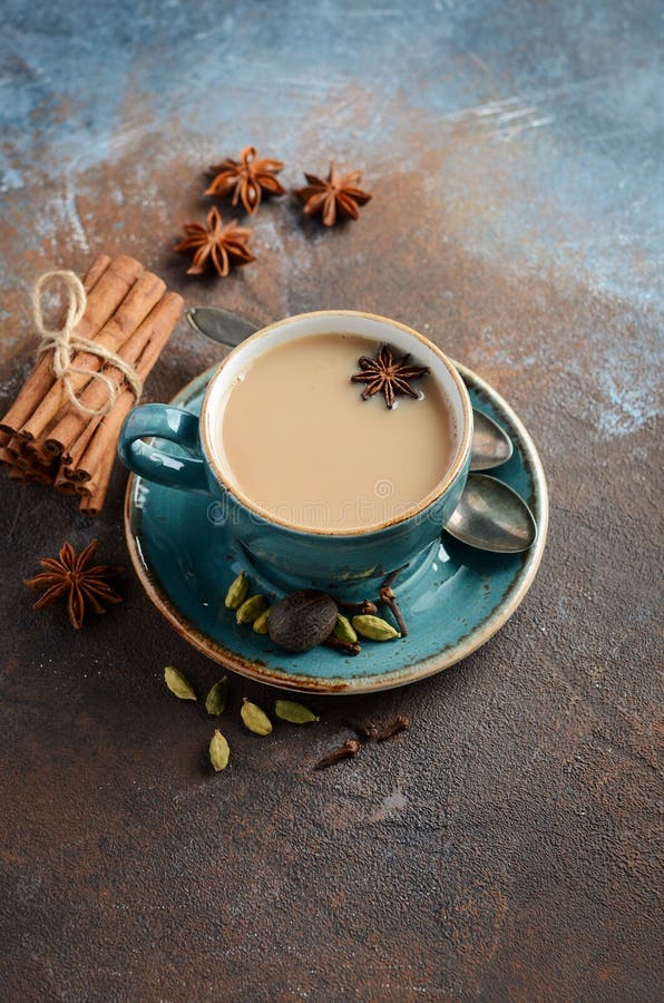 Indian masala chai tea. Spiced tea with milk on dark rusty background. royalty free stock photos