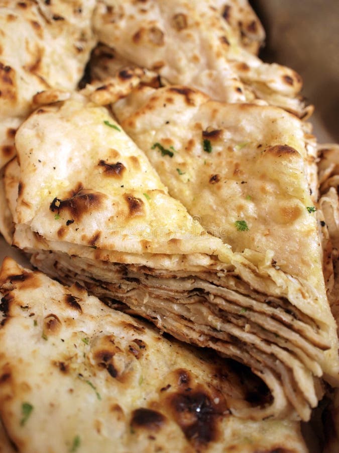 Closeup of a stack of Indian naan bread in an Indian cuisine.