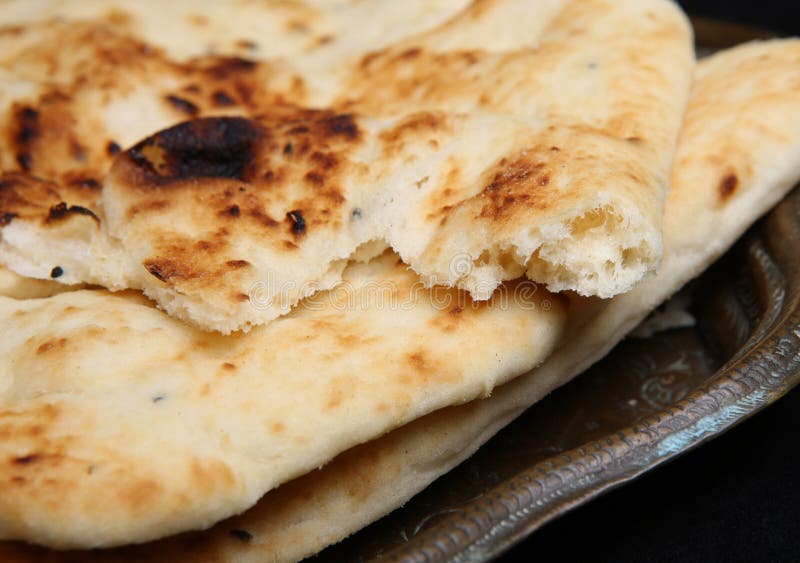 Indian naan bread on an old copper Indian plate.