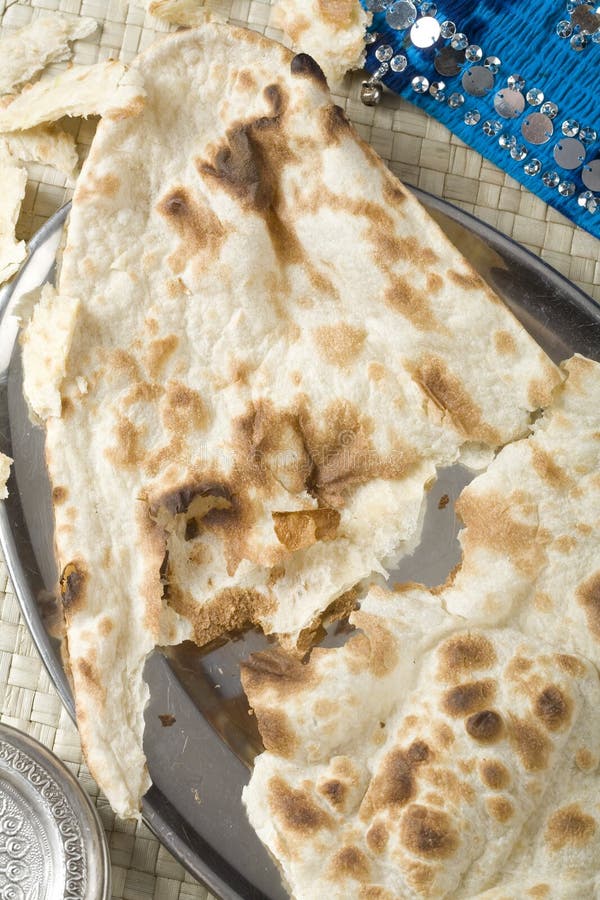 Indian Naan bread on steel plate. Indian Naan bread on steel plate