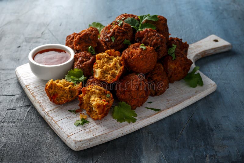 Indian Pakora snack spicy onion, red pepper with chilli sauce on white wooden board stock photo Indian Pakora snack spicy onion, red pepper with chilli sauce on white wooden board stock photo