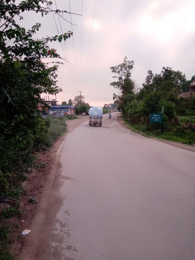 Indian road and going to loaded jeep on road stock photo Indian road and going to loaded jeep on road stock photo
