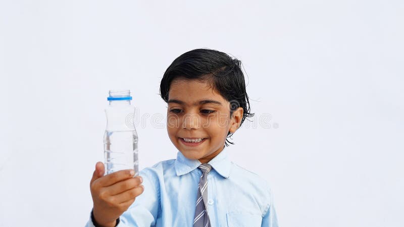 Indian boy carrying water bottle hi-res stock photography and