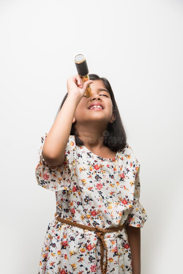 Indian small girl using telescope and studying space science stock image Indian small girl using telescope and studying space science stock image