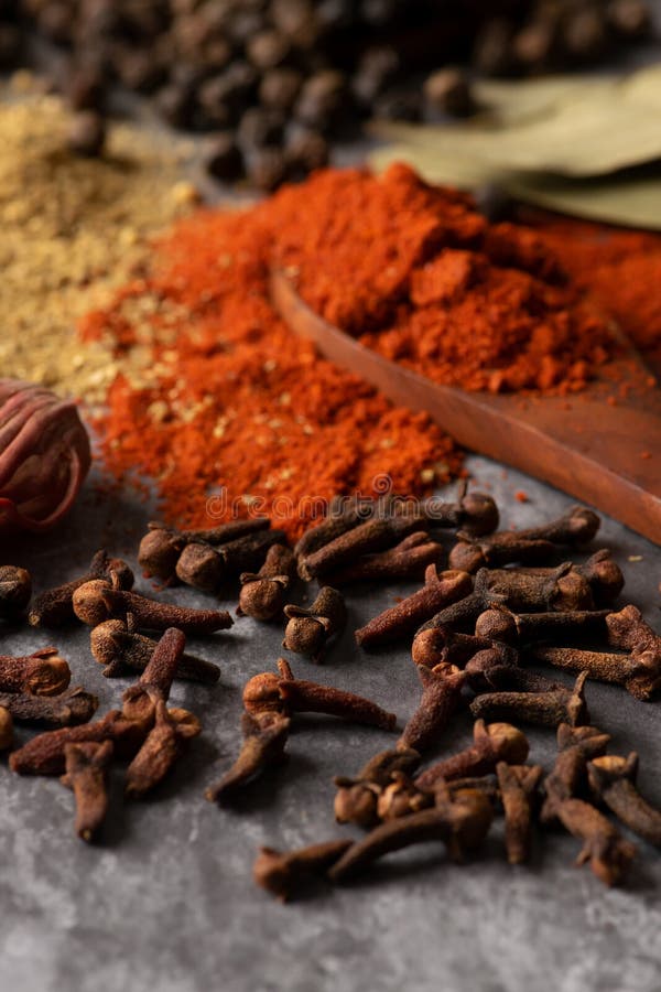 Indian Spices Clove with Chilli Powder and Coriander Powder in Background. Stock Photo Image