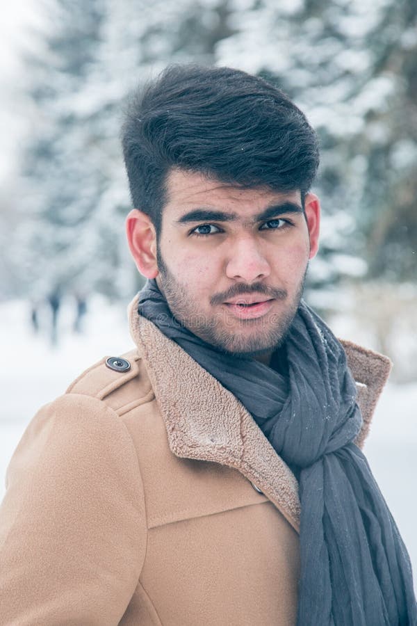 Indian Student Guy Smiles and Laughs in a Snowy City. Winter Holidays ...