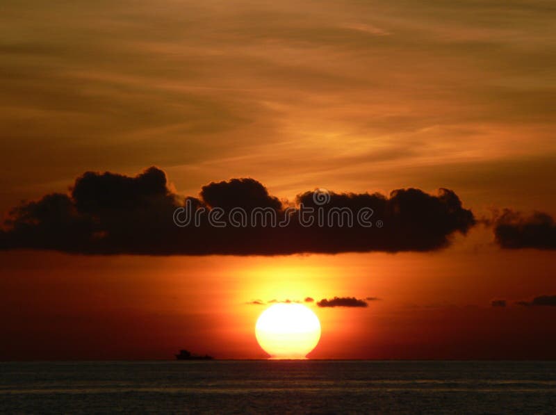 The sun hits the Indian Ocean as it sets at the end of a nother beautiful day in the Maldives. The sun hits the Indian Ocean as it sets at the end of a nother beautiful day in the Maldives