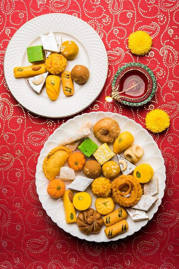 Indian sweets or Mithai for diwali festival with oil lamp or diya and gift box