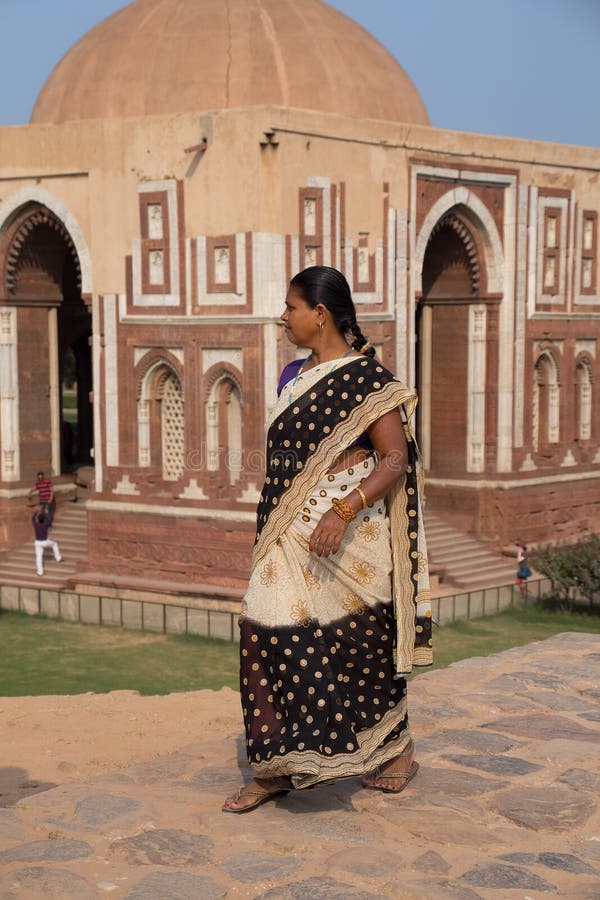 Indian woman walking near Alai gate, Qutub Minar, Delhi, India stock photo Indian woman walking near Alai gate, Qutub Minar, Delhi, India stock photo