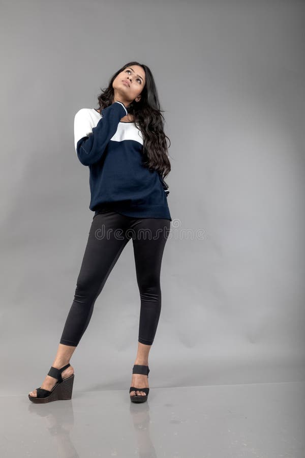 Indian Young Female Model in Casual Winterwear Against Grey Background.  Long Black Haired Model Wearing Black Leggings, Blue and Stock Photo -  Image of length, gesture: 294646108