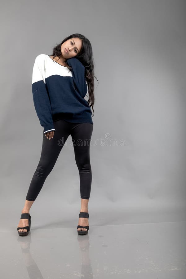 Indian Young Female Model in Casual Winterwear Against Grey Background.  Long Black Haired Model Wearing Black Leggings, Blue and Stock Photo -  Image of length, gesture: 294646108