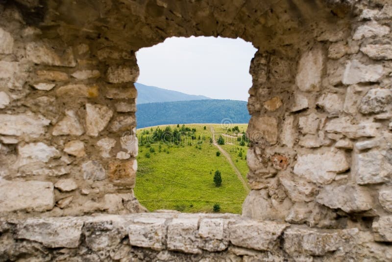 Stone window with vista on meadow. Stone window with vista on meadow