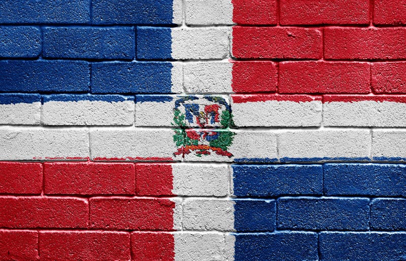 Indicateur de la république dominicaine sur un mur de briques photos stock Indicateur de la république dominicaine sur un mur de briques photos stock