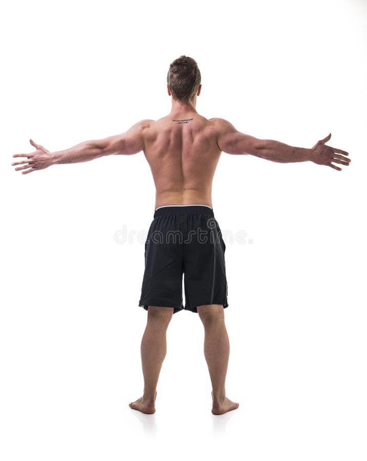 Indietro di giovane uomo del muscolo senza camicia con le armi fotografia stock libera da diritti Indietro di giovane uomo del muscolo senza camicia con le armi fotografia stock libera da diritti